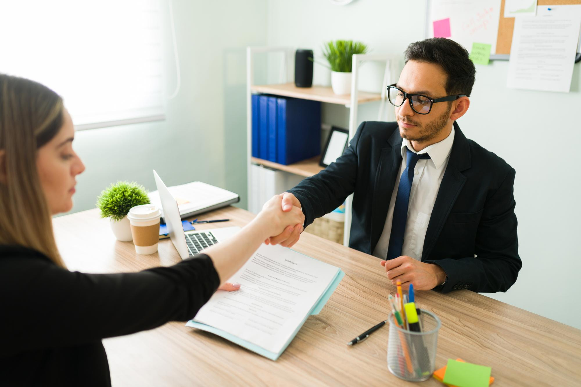 business-partner-suit-shaking-hands-with-caucasian-professional-colleague-blond-woman-signing-deal-contract-with-lawyer-corporate-office